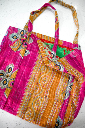 a pink and orange bag sitting on top of a table