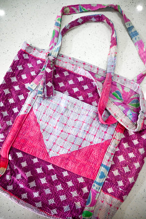 a pink and white bag sitting on top of a counter