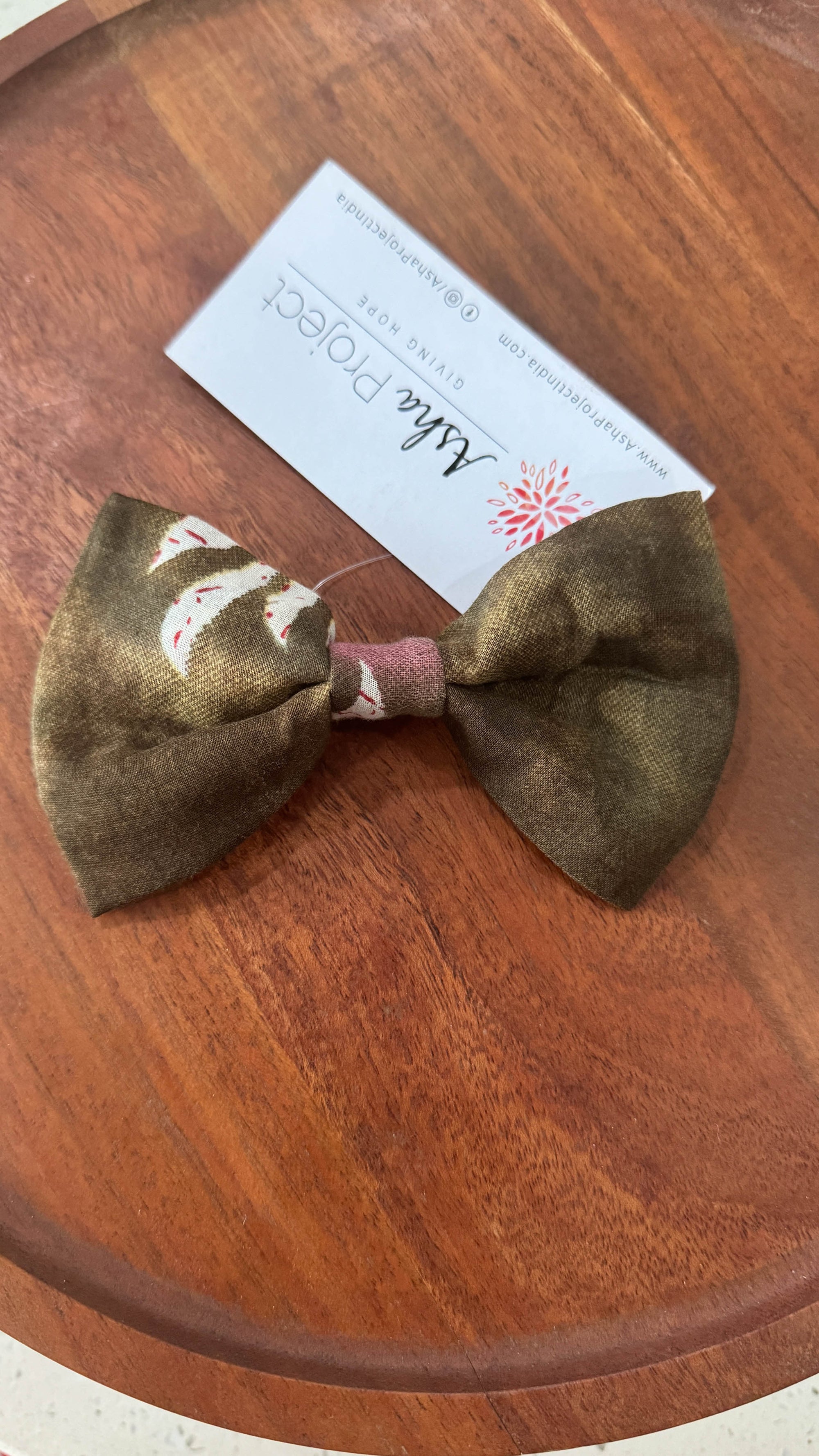 a wooden table with a bow tie on top of it