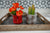 a tray with two potted plants sitting on top of it