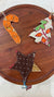 a wooden table topped with a wooden tray covered in ornaments