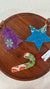 a wooden table topped with a wooden tray covered in ornaments