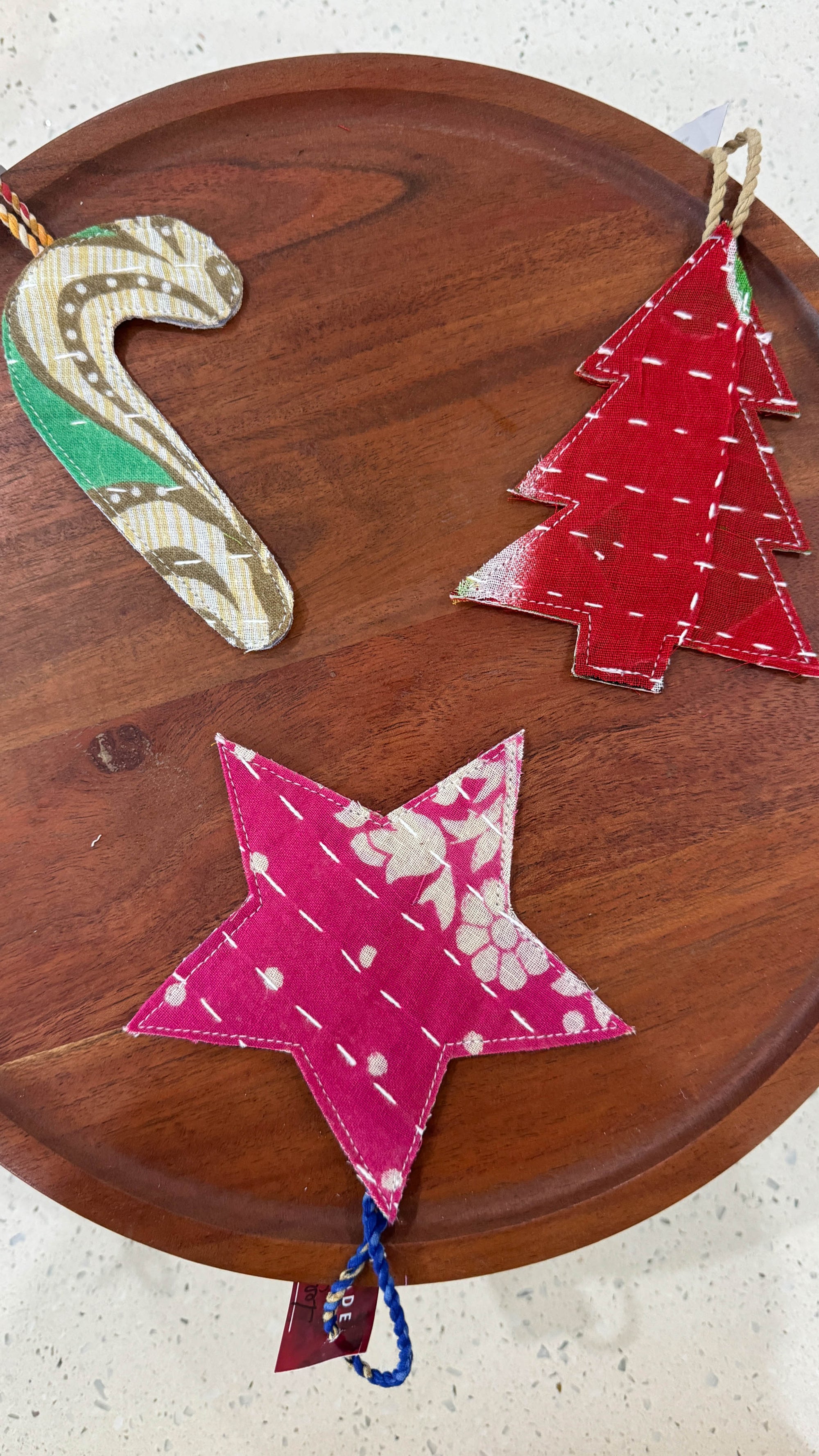 a wooden table topped with three christmas trees