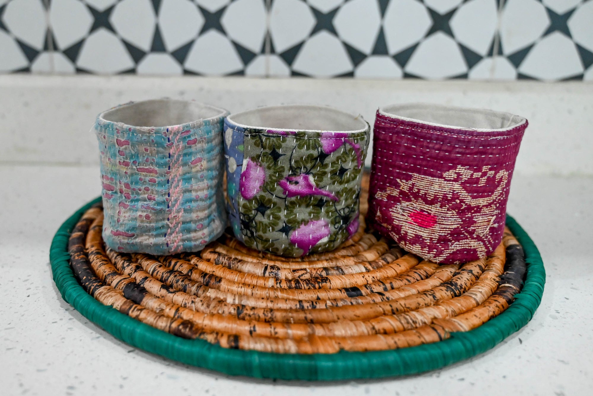 three cups sitting on top of a wicker tray