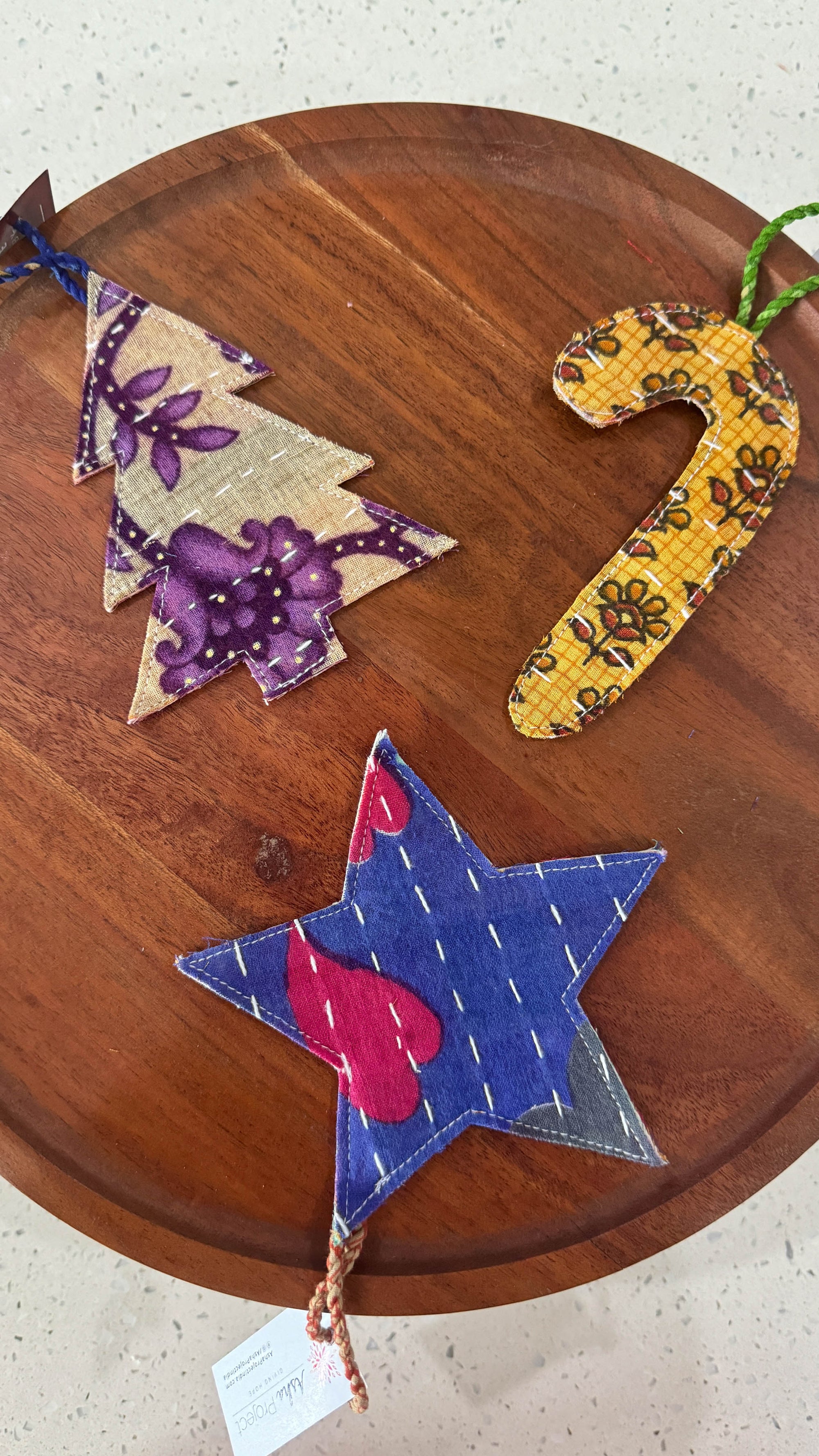 a wooden table topped with three colorful stars