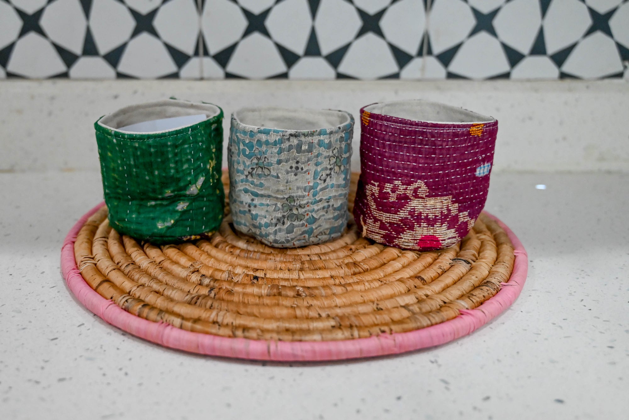 three cups sitting on top of a wicker tray