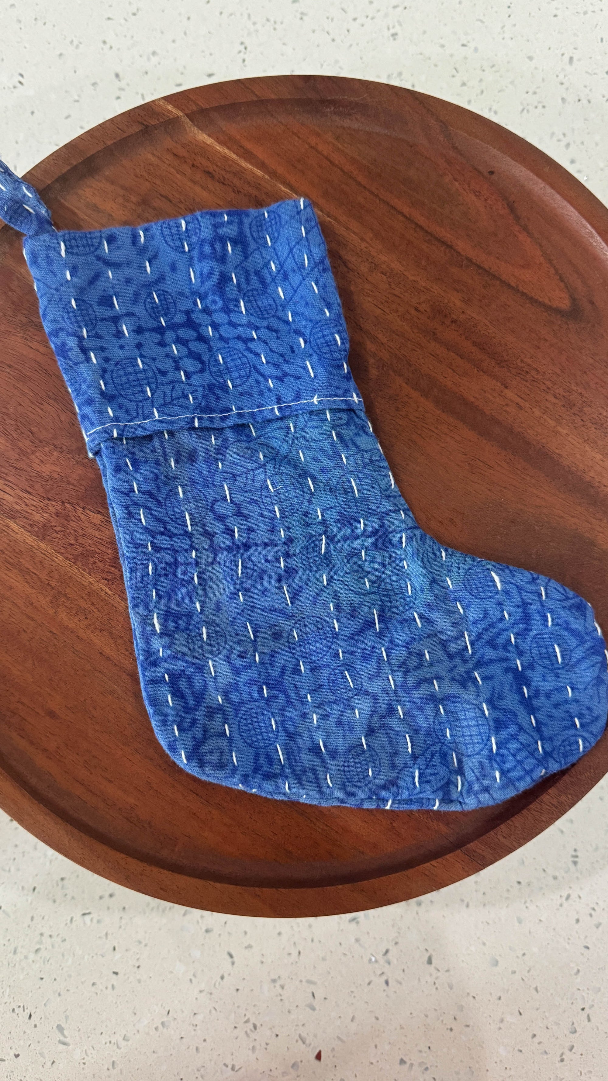 a wooden table topped with a blue piece of cloth