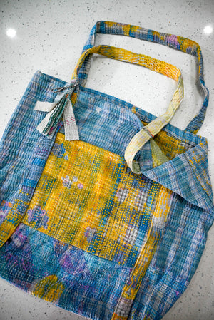 a blue and yellow bag sitting on top of a counter