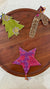 a wooden table topped with a wooden tray covered in paper cut outs