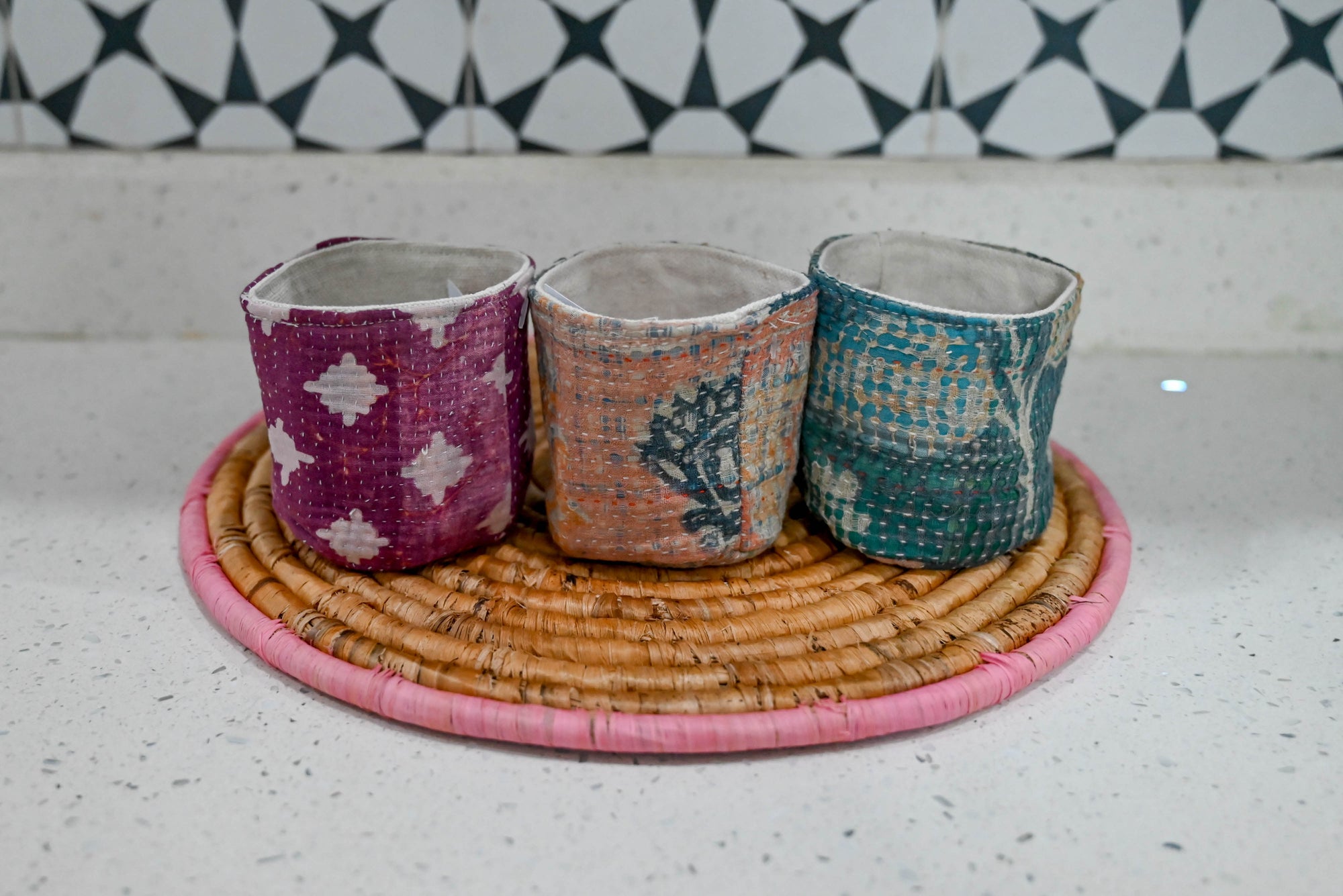 three cups sitting on top of a wicker tray