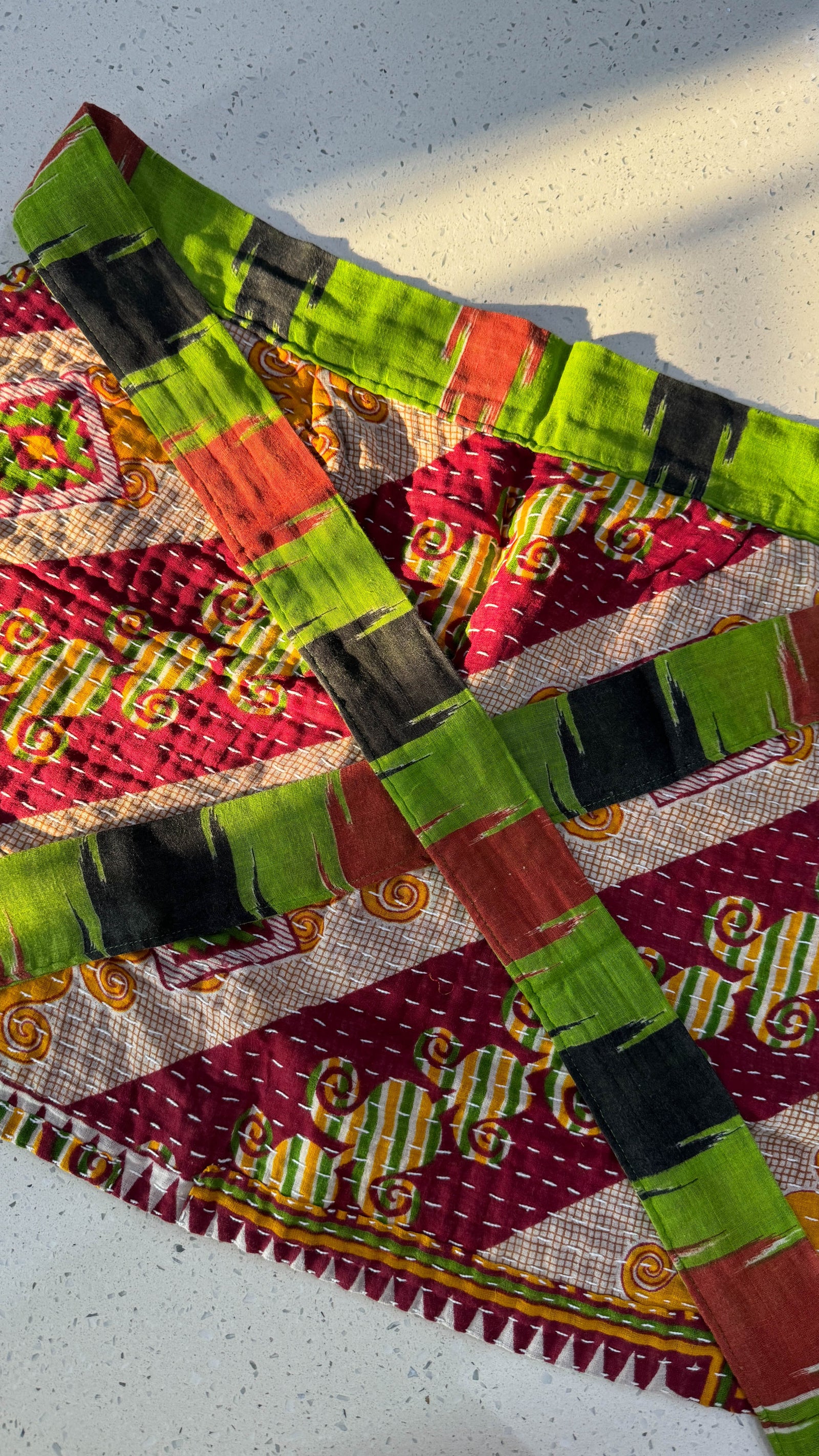 Handmade Kantha half apron with intricate stitching and vibrant fabric patterns, perfect for adding a touch of traditional style to your kitchen while cooking or crafting.