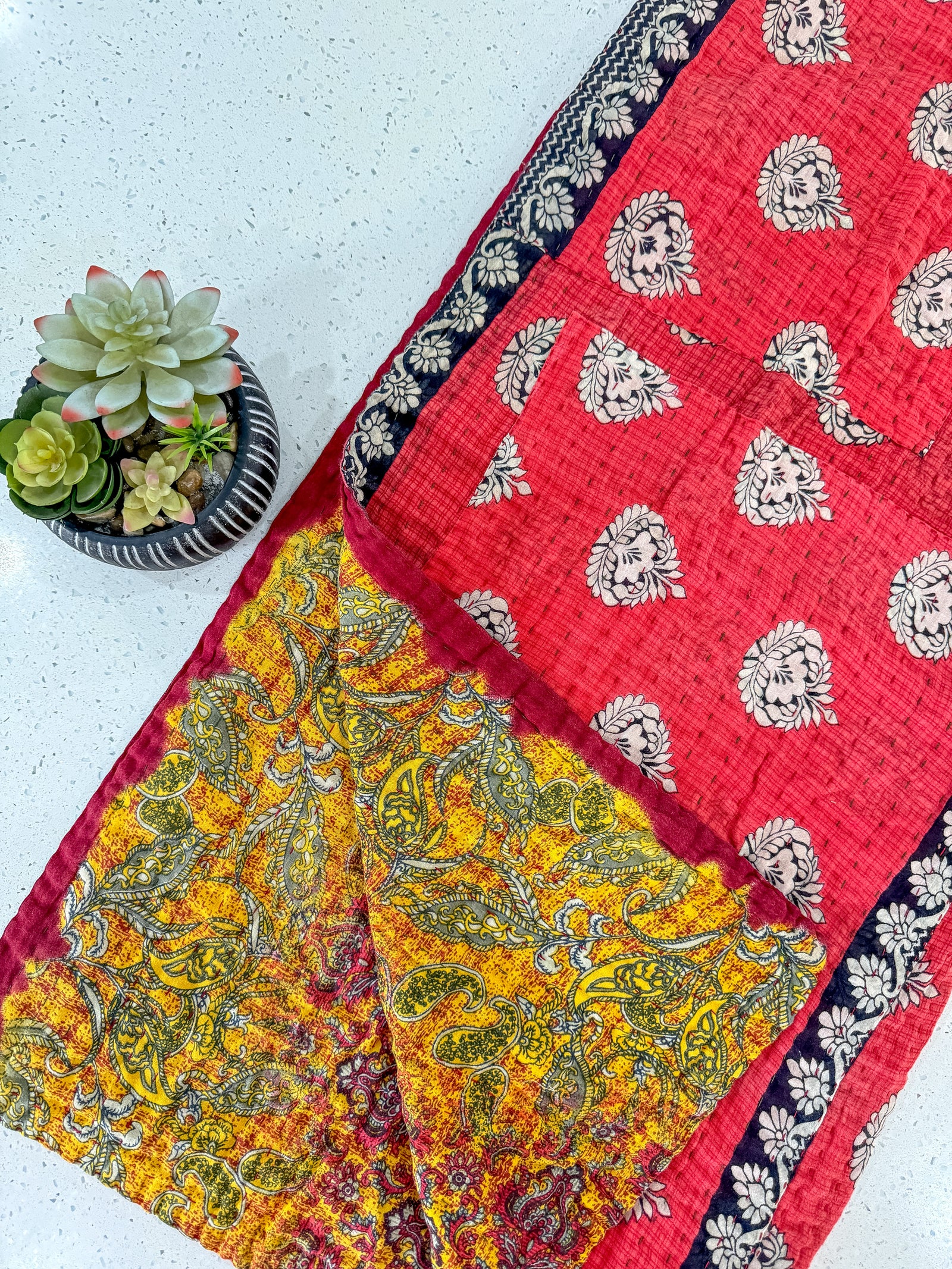 Handmade Kantha blanket made from recycled saree fabric, featuring colorful patchwork and traditional running stitches.

Bright bohemian sari Kantha throw blanket with unique stitched design, perfect for bedding or home decor.