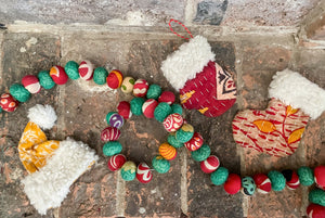 Hand-stitched Kantha stocking, hat, and mitten ornaments with a wool cuff. Available in bold colors, ideal for hanging on Christmas trees.