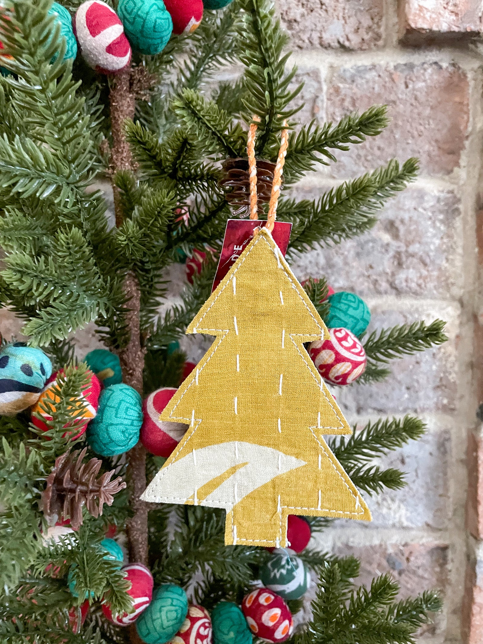 Handmade Kantha candy cane ornament with Kantha stitched vibrant sarees, perfect for dressing up your tree with a unique, colorful touch of traditional style this holiday season.