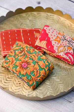 Kantha coffee cozy featuring colorful, hand-stitched patterns, designed to wrap around your cup and protect your hands from both heat and cold.