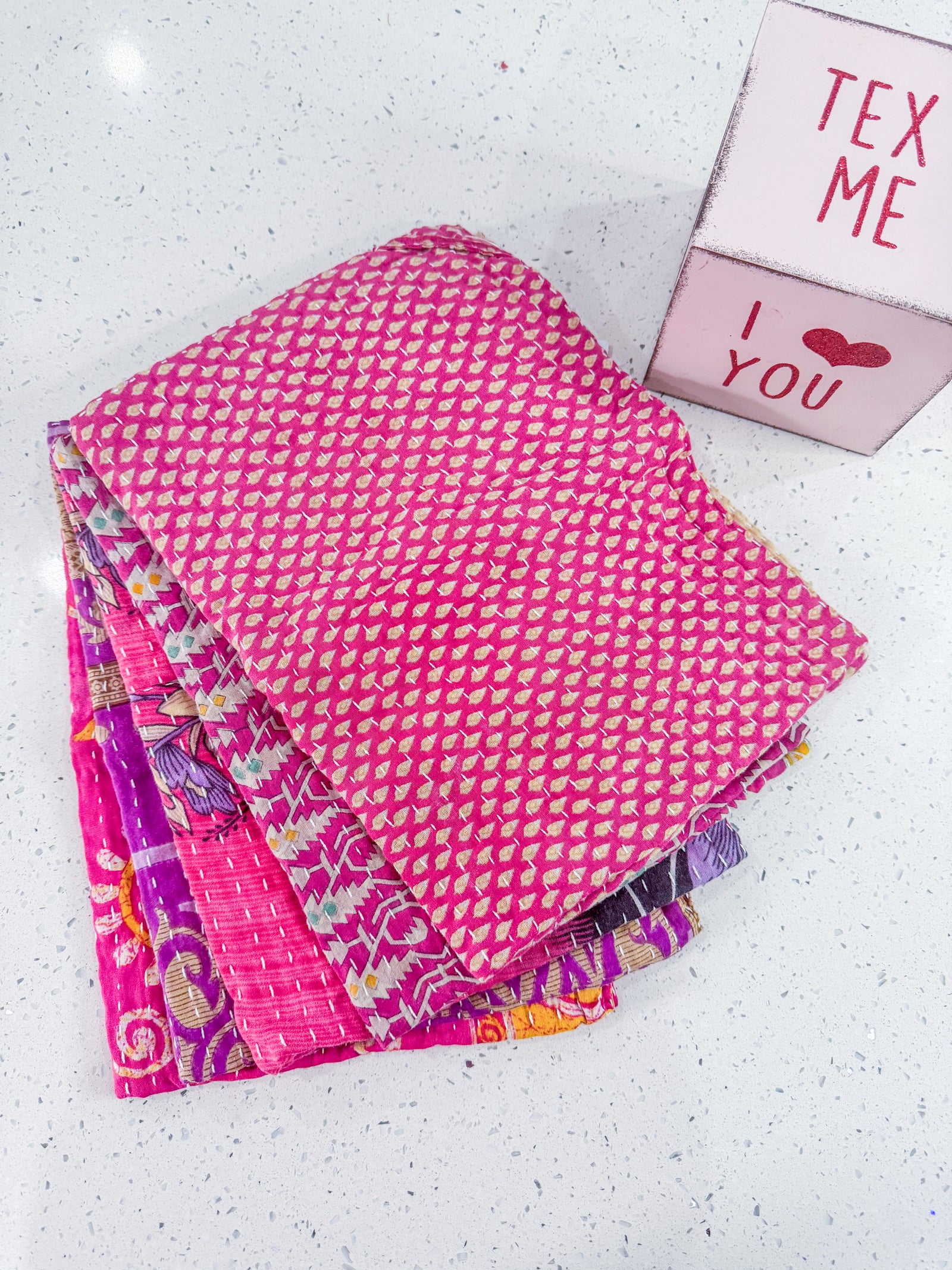 Kantha kitchen towels made from hand-stitched, colorful fabric, perfect for adding an eco-friendly and vibrant touch to your kitchen while offering practical use.