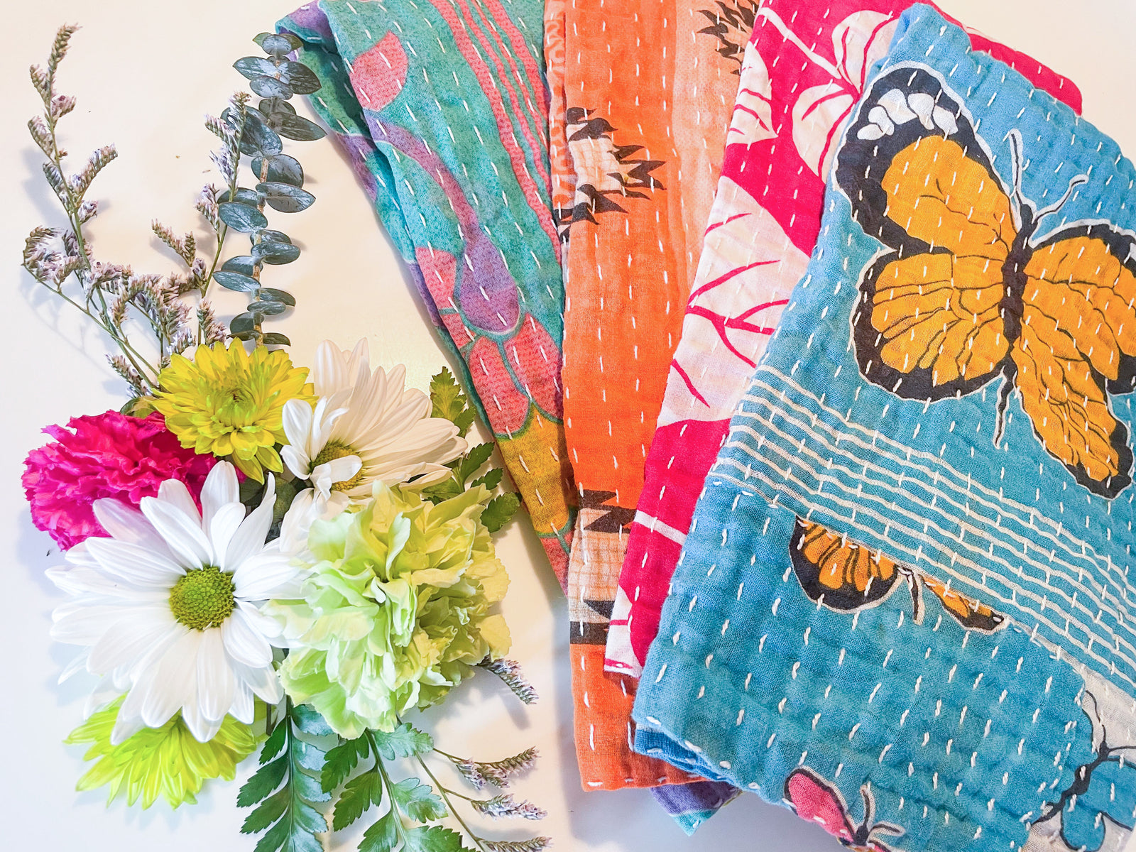 Spring-inspired Kantha kitchen towels with colorful patchwork designs and hand-stitched details in pastel pink, green, and yellow. Lightweight and textured, perfect for brightening up your kitchen.