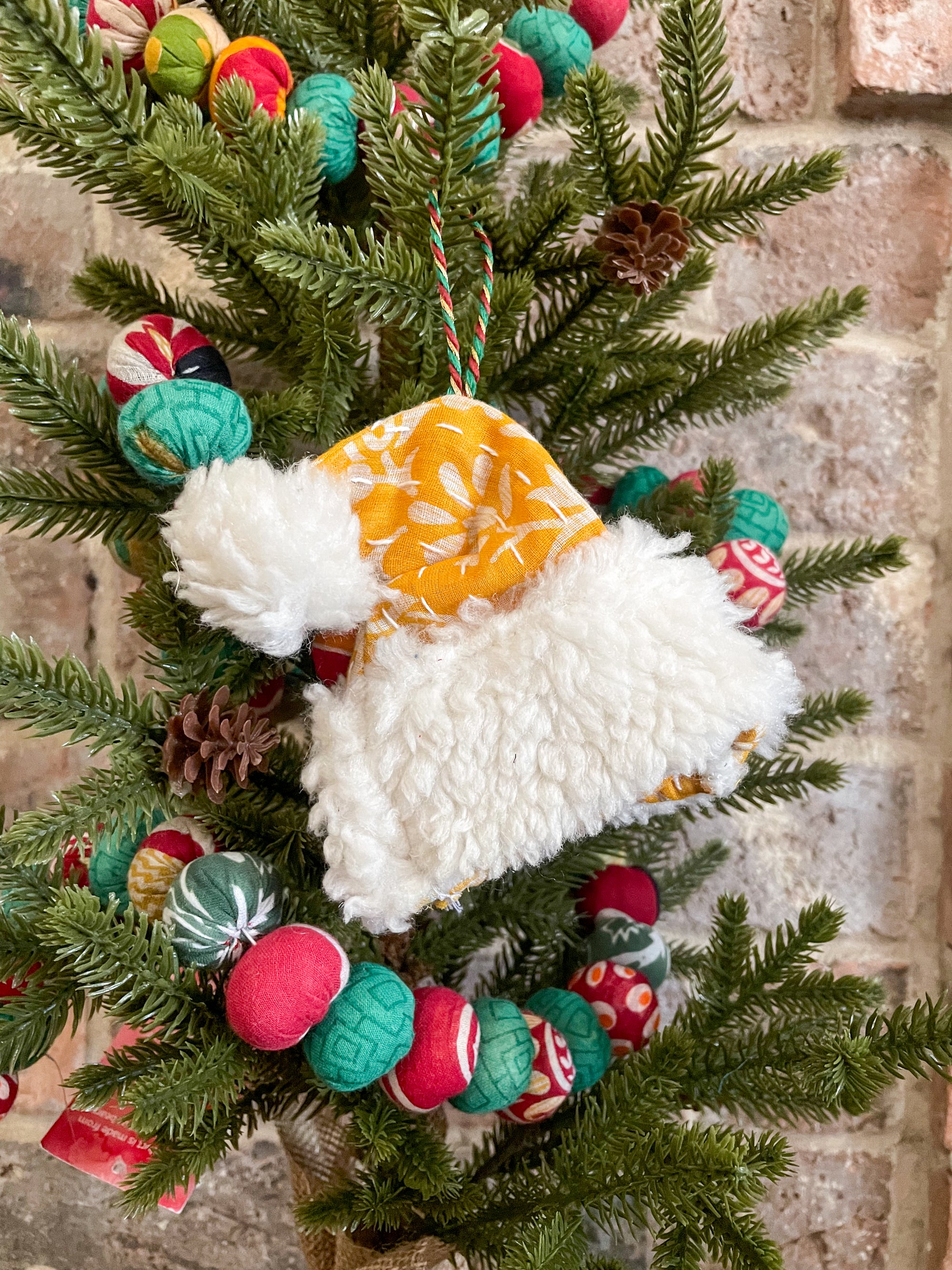 Hand-stitched Kantha stocking, mitten, and Santa hat ornament with a wool cuff. Available in bold colors, ideal for hanging on Christmas trees.