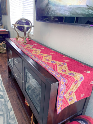 Reversible kantha table runner featuring two vibrant saree  patterns. The runner is stitched with delicate kantha embroidery, adding texture and charm to both sides.