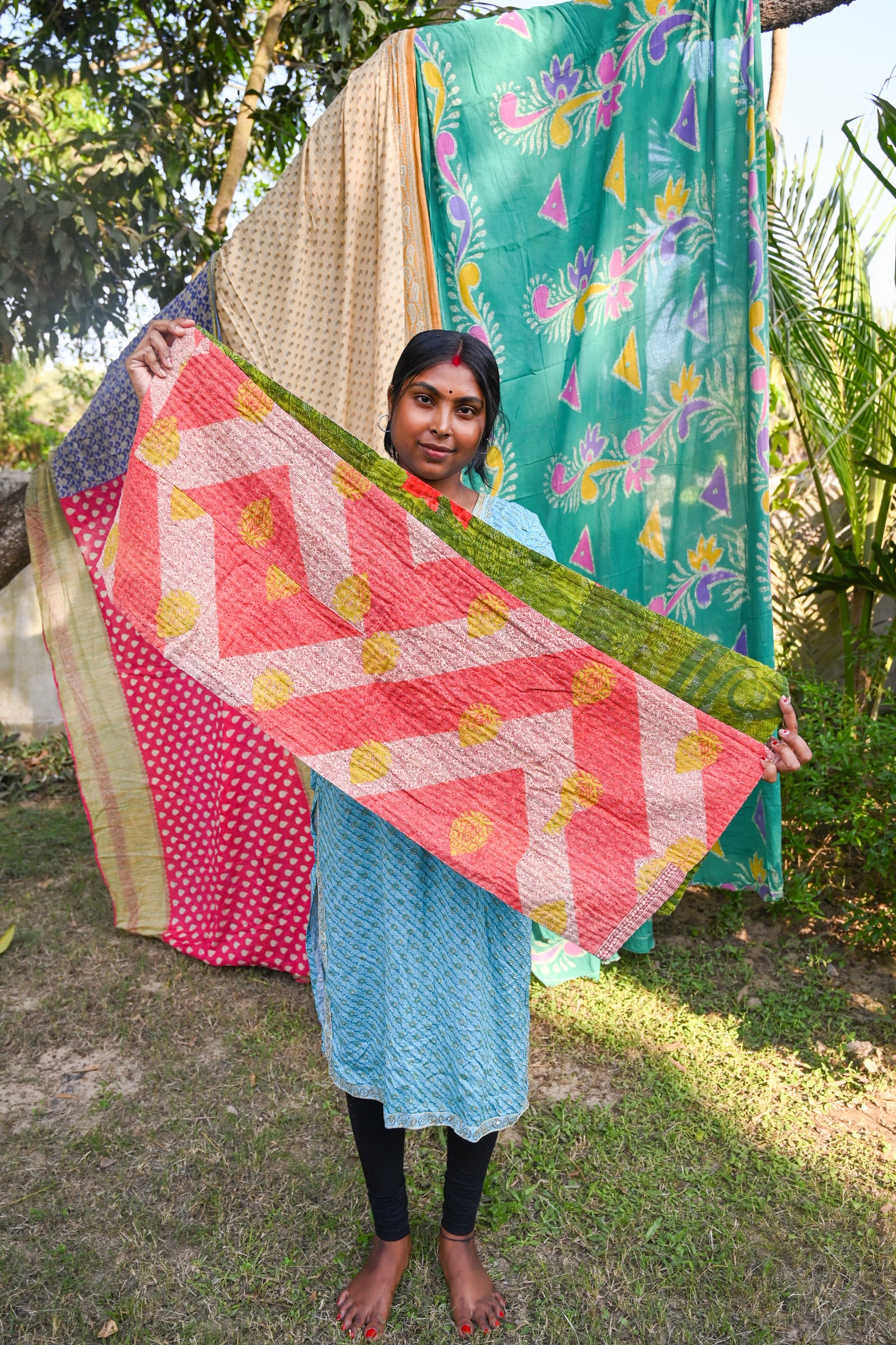 Reversible kantha table runner featuring two vibrant saree  patterns. The runner is stitched with delicate kantha embroidery, adding texture and charm to both sides.