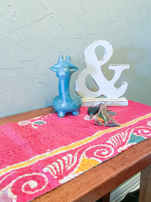 Reversible kantha table runner featuring two vibrant saree  patterns. The runner is stitched with delicate kantha embroidery, adding texture and charm to both sides.