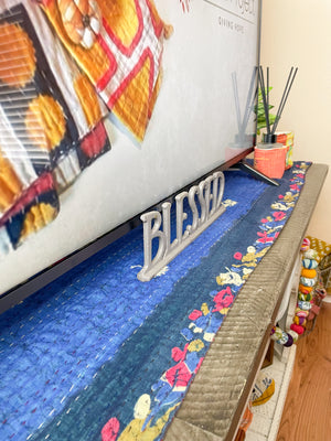 Reversible kantha table runner featuring two vibrant saree  patterns. The runner is stitched with delicate kantha embroidery, adding texture and charm to both sides.