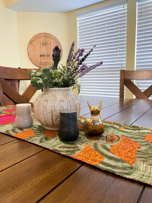 Reversible kantha table runner featuring two vibrant saree  patterns. The runner is stitched with delicate kantha embroidery, adding texture and charm to both sides.