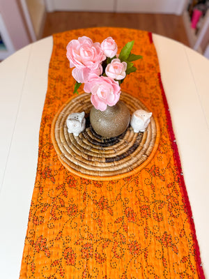 Reversible kantha table runner featuring two vibrant saree  patterns. The runner is stitched with delicate kantha embroidery, adding texture and charm to both sides.