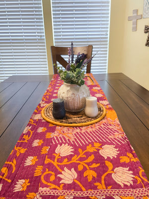 Reversible kantha table runner featuring two vibrant saree  patterns. The runner is stitched with delicate kantha embroidery, adding texture and charm to both sides.