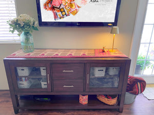 Reversible kantha table runner featuring two vibrant saree  patterns. The runner is stitched with delicate kantha embroidery, adding texture and charm to both sides.