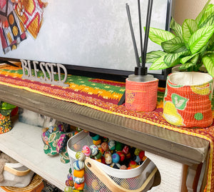 Reversible kantha table runner featuring two vibrant saree  patterns. The runner is stitched with delicate kantha embroidery, adding texture and charm to both sides.