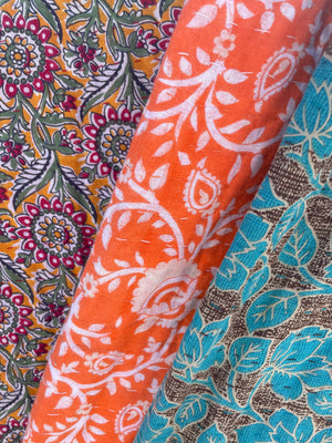 Handmade kantha throw blanket featuring kantha stitching, bright saree patterns, and sustainable practices, perfect for home decor.