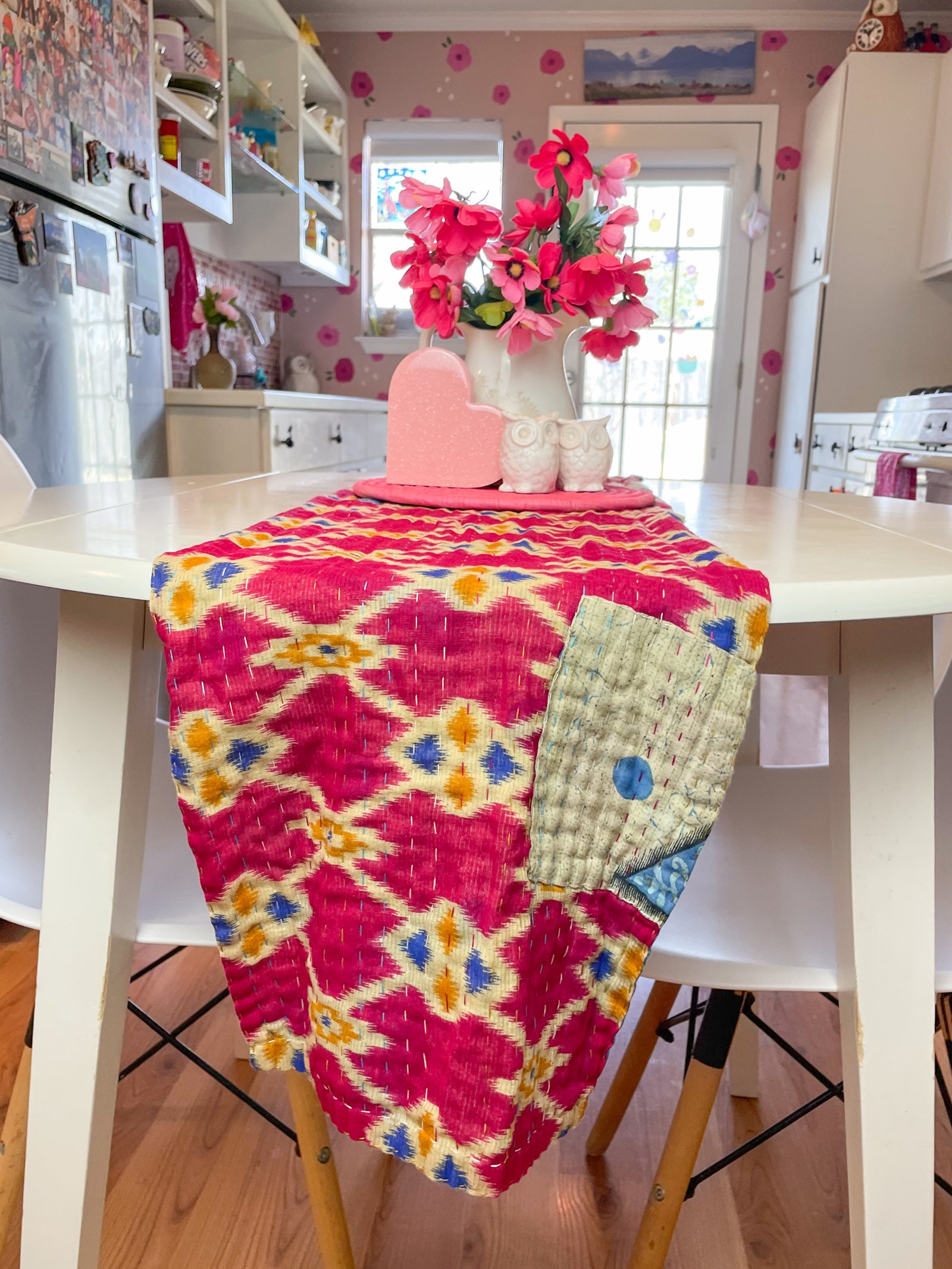 Reversible kantha table runner featuring two vibrant saree  patterns. The runner is stitched with delicate kantha embroidery, adding texture and charm to both sides.