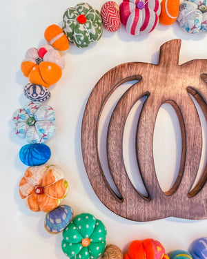 Wooden pumpkin trivet, ideal for fall kitchens. Keeps counters cool and doubles as a decorative piece when not in use.