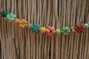 Mini saree pumpkin bead garland featuring small fabric pumpkins and colorful beads, creating a festive and eco-friendly fall or Halloween decoration.
