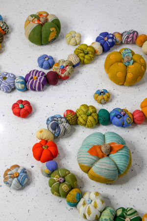 Mini saree pumpkin bead garland featuring small fabric pumpkins and colorful beads, creating a festive and eco-friendly fall or Halloween decoration.