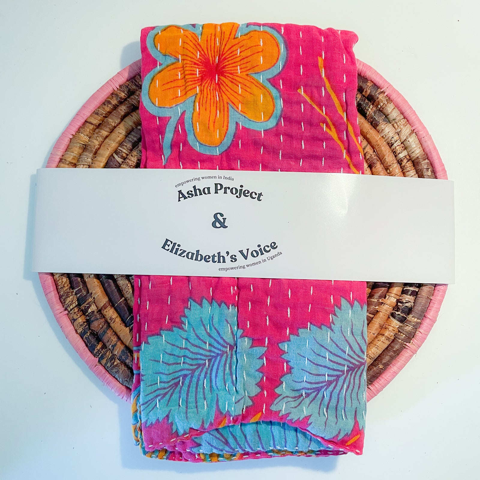 Handmade Kantha kitchen towel paired with a banana leaf trivet, featuring vibrant fabric patterns and eco-friendly materials, perfect for adding a colorful and functional touch to your kitchen.