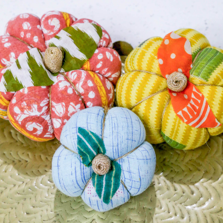 Upcycled saree pumpkin, unique autumn decoration with vibrant patterns.