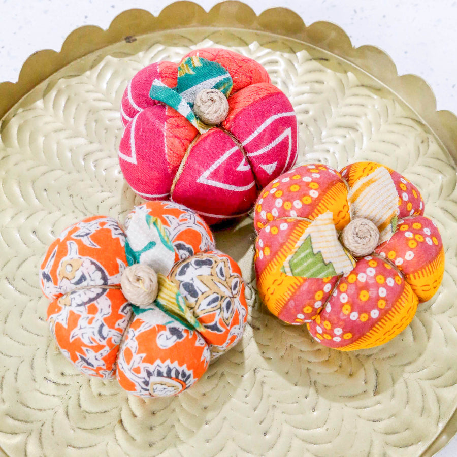 Upcycled saree pumpkin, unique autumn decoration with vibrant patterns.