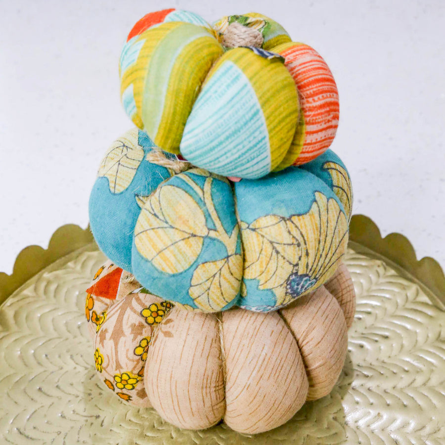 Upcycled saree pumpkin, unique autumn decoration with vibrant patterns.
