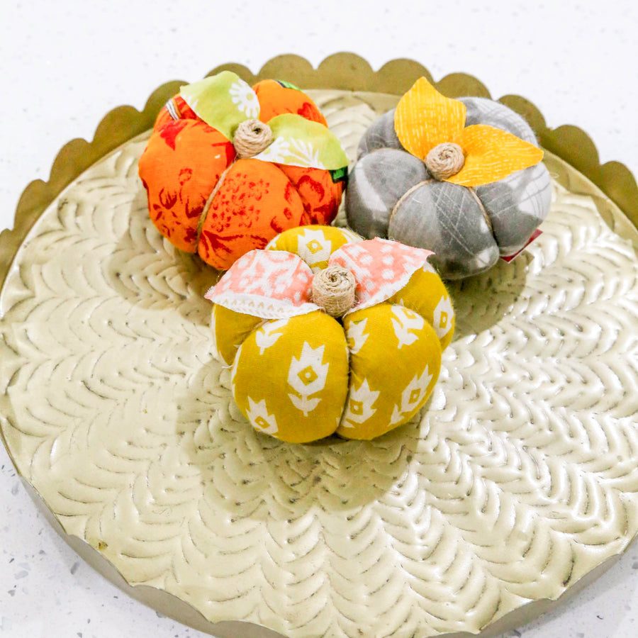 Upcycled saree pumpkin, unique autumn decoration with vibrant patterns.