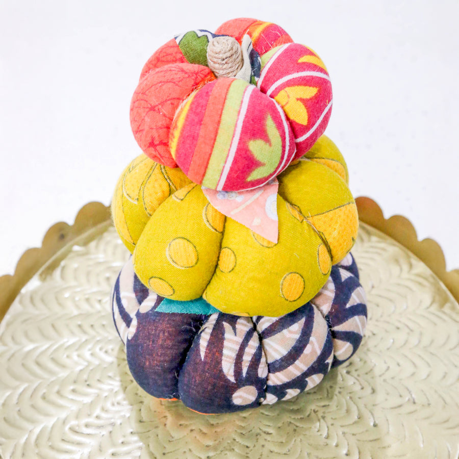 Upcycled saree pumpkin, unique autumn decoration with vibrant patterns.