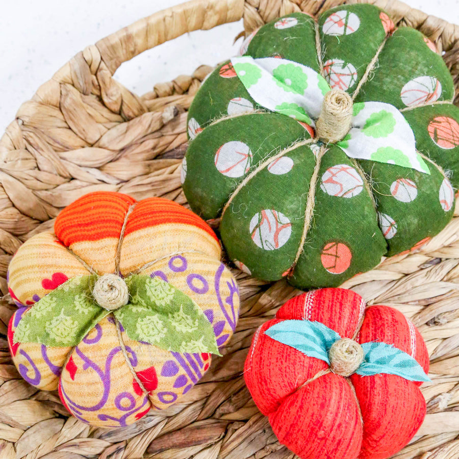 Upcycled saree pumpkin, unique autumn decoration with vibrant patterns.