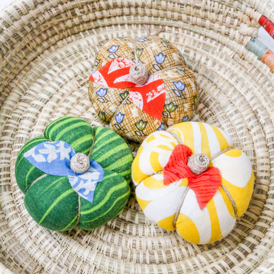 Upcycled saree pumpkin, unique autumn decoration with vibrant patterns.