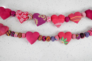 Saree heart garland made from colorful, recycled saree fabric hearts, strung together with Saree beads to create a vibrant and eco-friendly decoration for home or special occasions.
