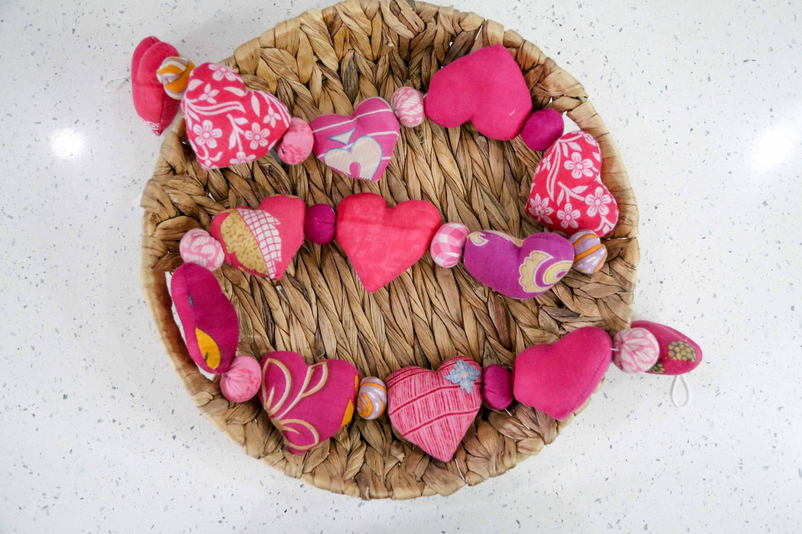 Saree heart garland made from colorful, recycled saree fabric hearts, strung together with Saree beads to create a vibrant and eco-friendly decoration for home or special occasions.