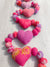 Saree heart garland made from colorful, recycled saree fabric hearts, strung together with Saree beads to create a vibrant and eco-friendly decoration for home or special occasions.