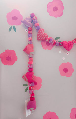 Saree heart garland made from colorful, recycled saree fabric hearts, strung together with Saree beads to create a vibrant and eco-friendly decoration for home or special occasions.