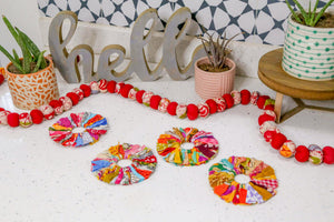 Set of 4 round coasters made from colorful saree scraps, hand-tied to create a vibrant and eco-friendly addition to your home décor.