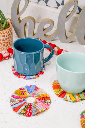 Set of 4 round coasters made from colorful saree scraps, hand-tied to create a vibrant and eco-friendly addition to your home décor.